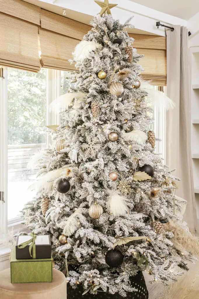 flocked christmas tree with neutral ornaments