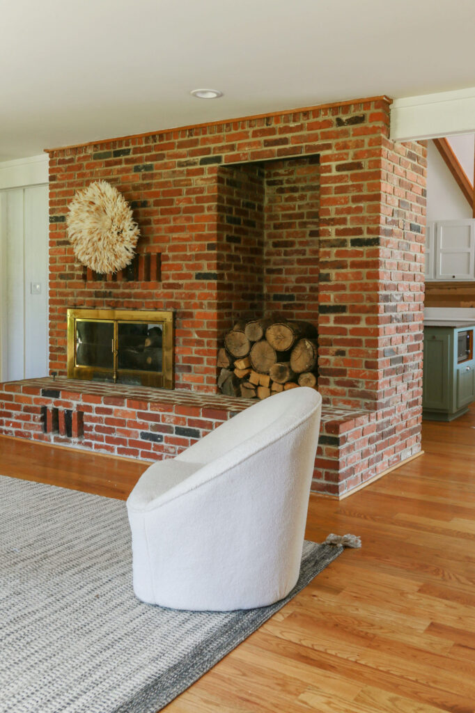cozy modern organic living room with brick fireplace and white walls