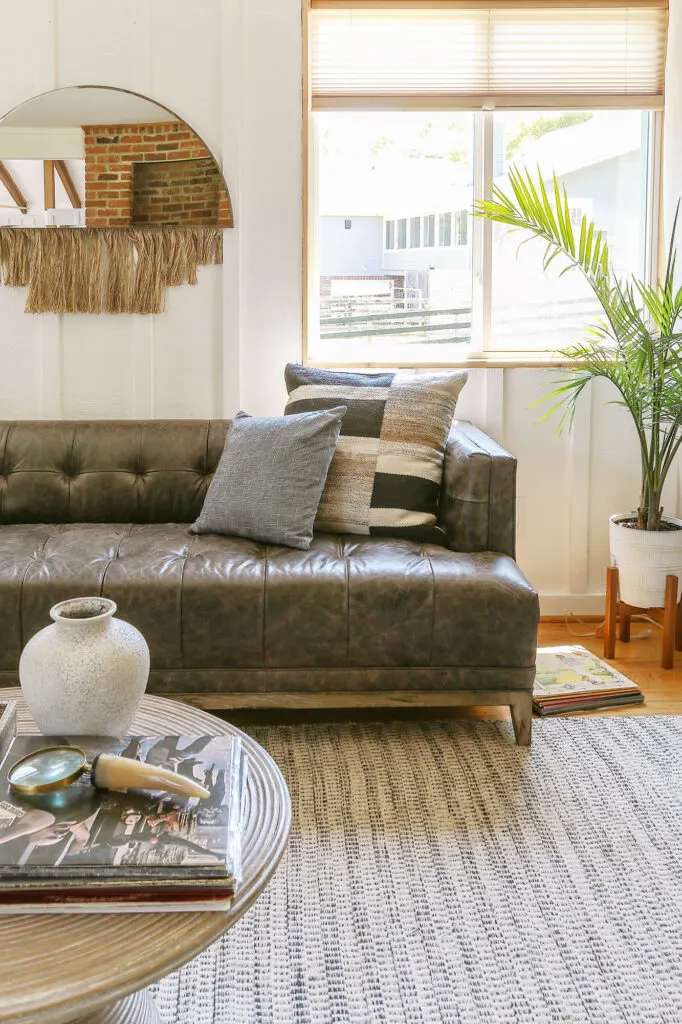 midcentury modern living room with leather sofa and white walls