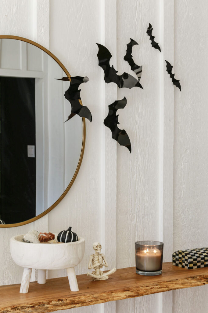 neutral and minimal halloween decor with pumpkins and skeletons