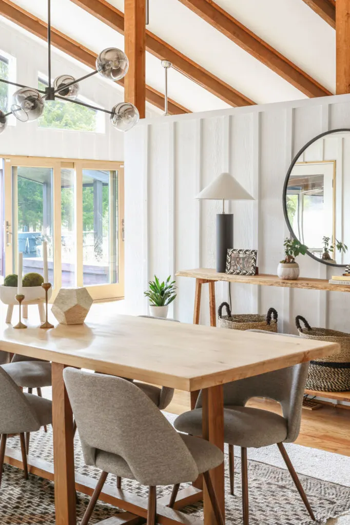 neutral modern dining room with wood beams and white walls