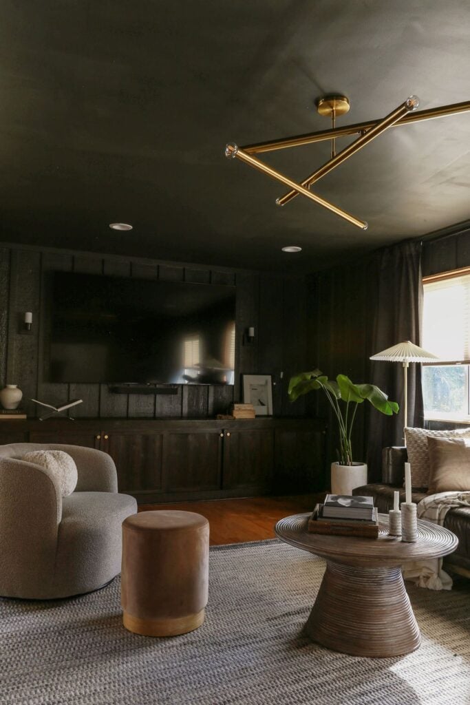 moody living room with walls and ceilings painted in Iron Ore by Sherwin Williams