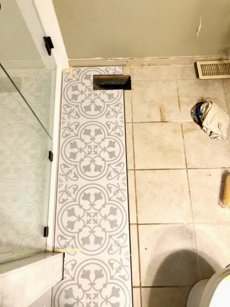 luxury vinyl tiles installed over ceramic tile bathroom floors