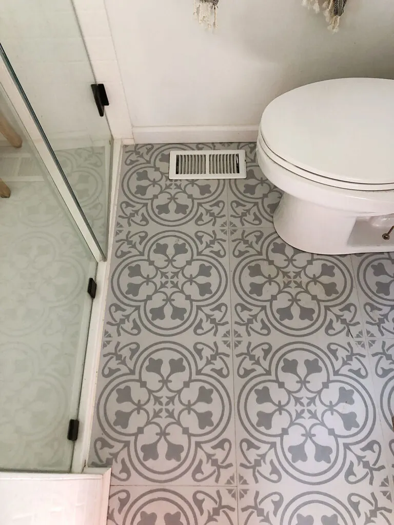 luxury vinyl plank installed around bathroom toilet and shower 