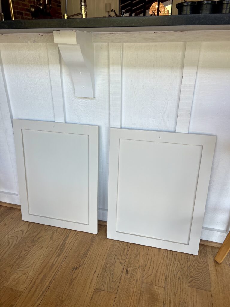 cabinet doors painted in Emerald Urethane in satin finish curing before install