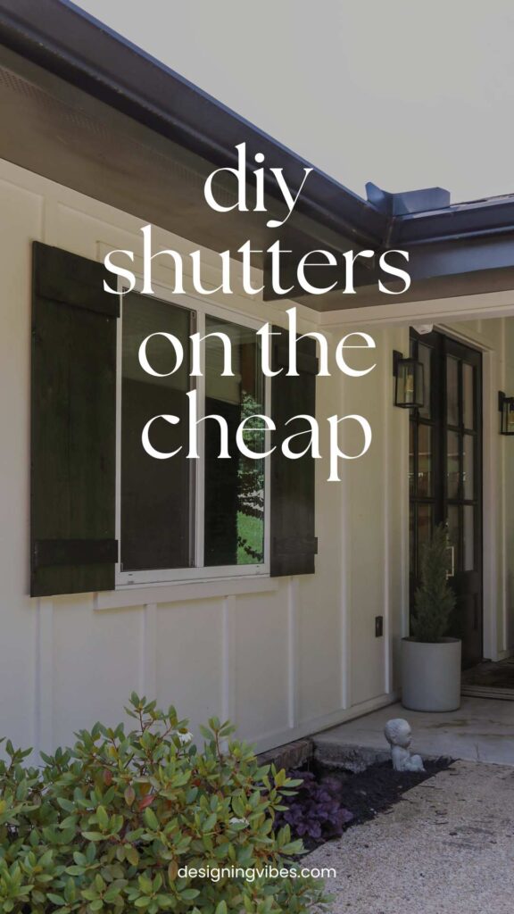 white house with diy black board and batten shutters