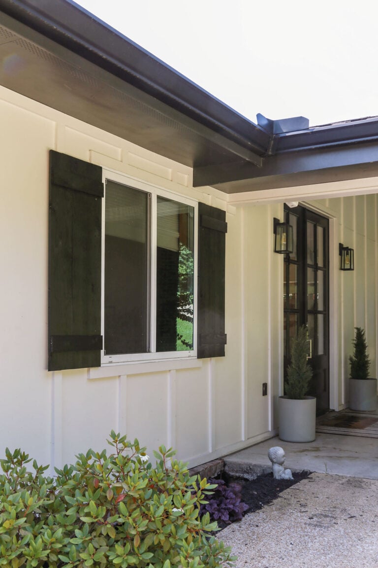 diy board and batten cedar shutters installed on a white house on a budget
