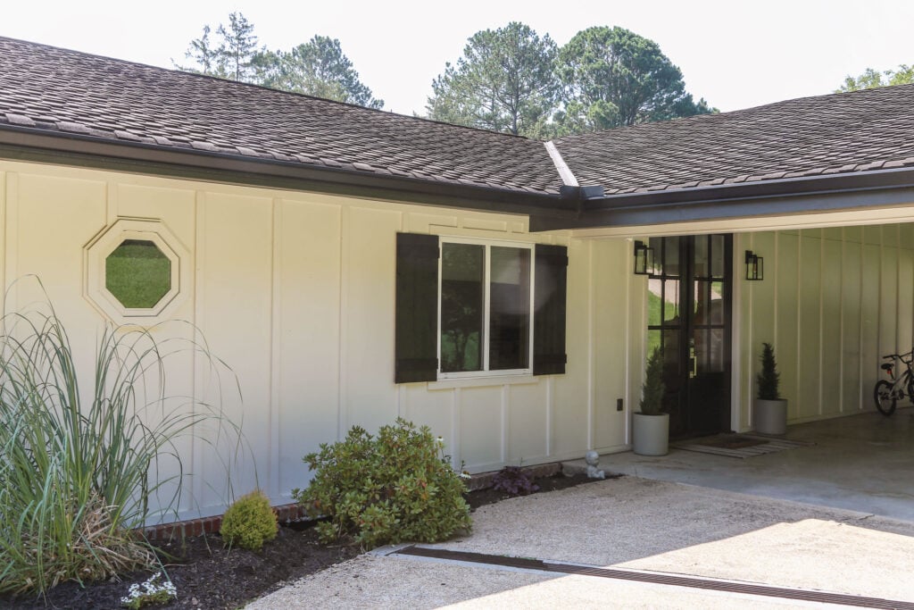 white modern farmhouse exterior painted in Shoji White with black diy board and batten shutters and black front door