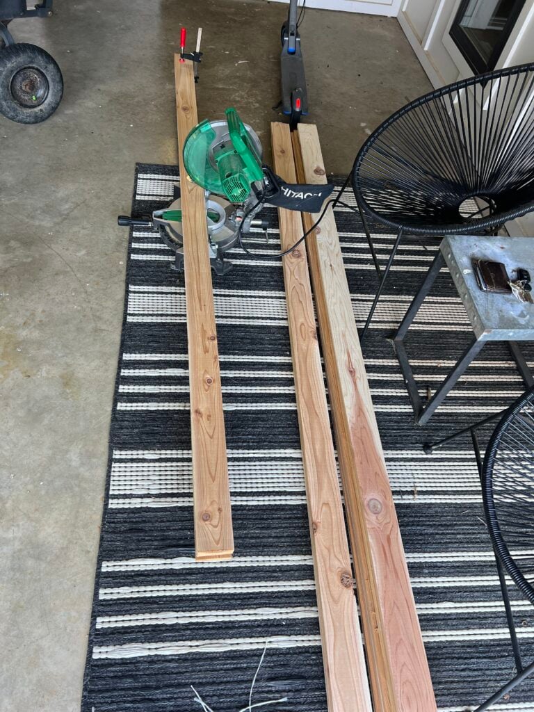 cutting cedar boards with saw to make shutters