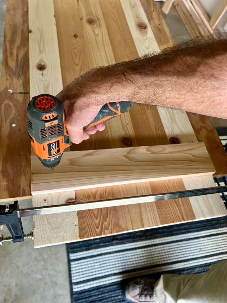 attaching the horizontal batten piece onto the shutter with a screwdriver
