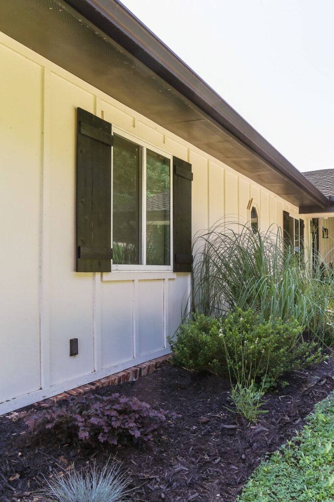 close up view of diy shutters installed on the front elevation of an all white exterior