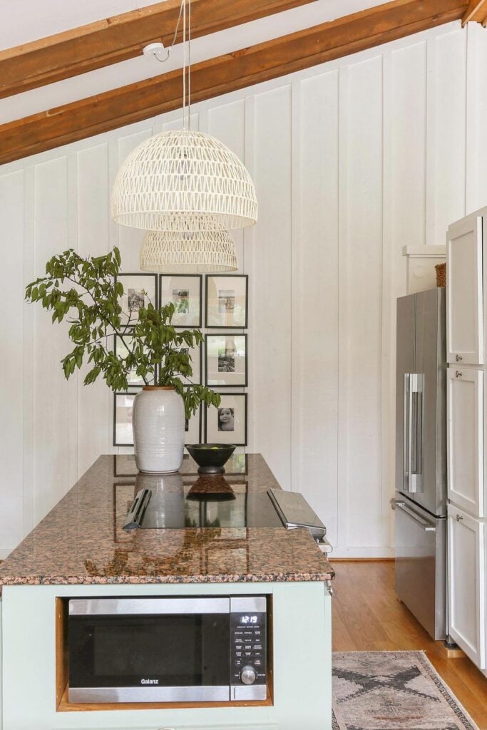 kitchen island cabinets painted in Coastal Plain by Sherwin Williams with white walls 