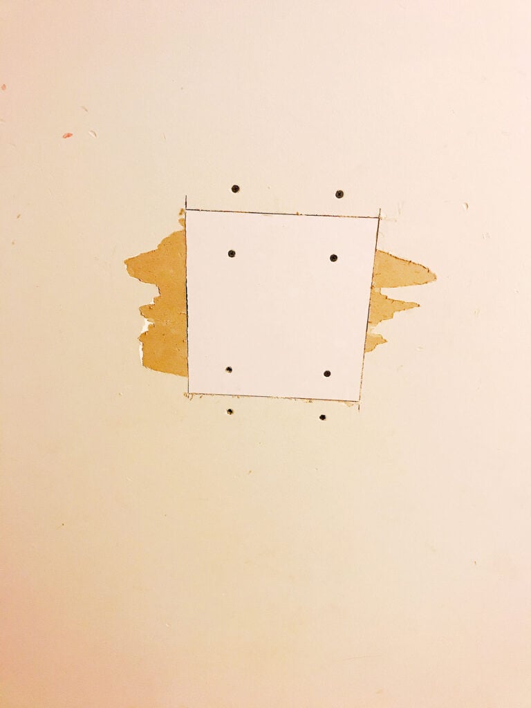 screwing in the drywall patch