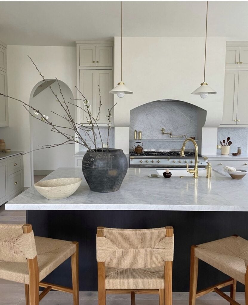 kitchen with marble countertops and backsplash paired with a greige cabinet color - Farrow and Ball Dropcloth. 