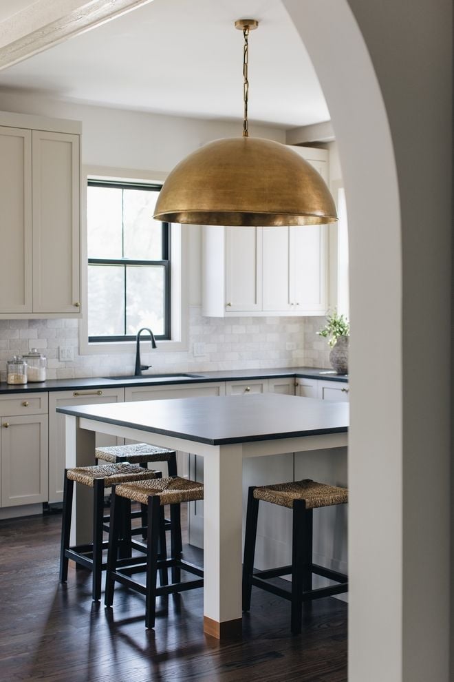 transitional kitchen with greige kitchen cabinets and black honed countertops