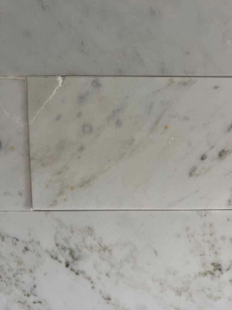 close up of where my marble peel and stick tile backsplash chipped