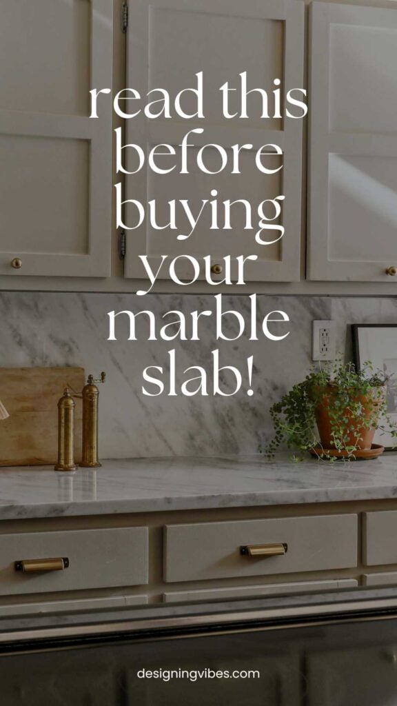 polished grey and white marble in greige kitchen with brass hardware