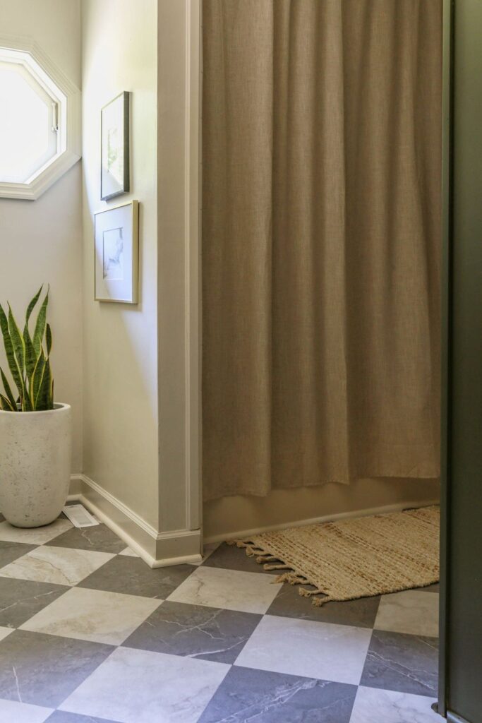 checkerboard vinyl peel and stick tiles on bathroom floor that look like marble