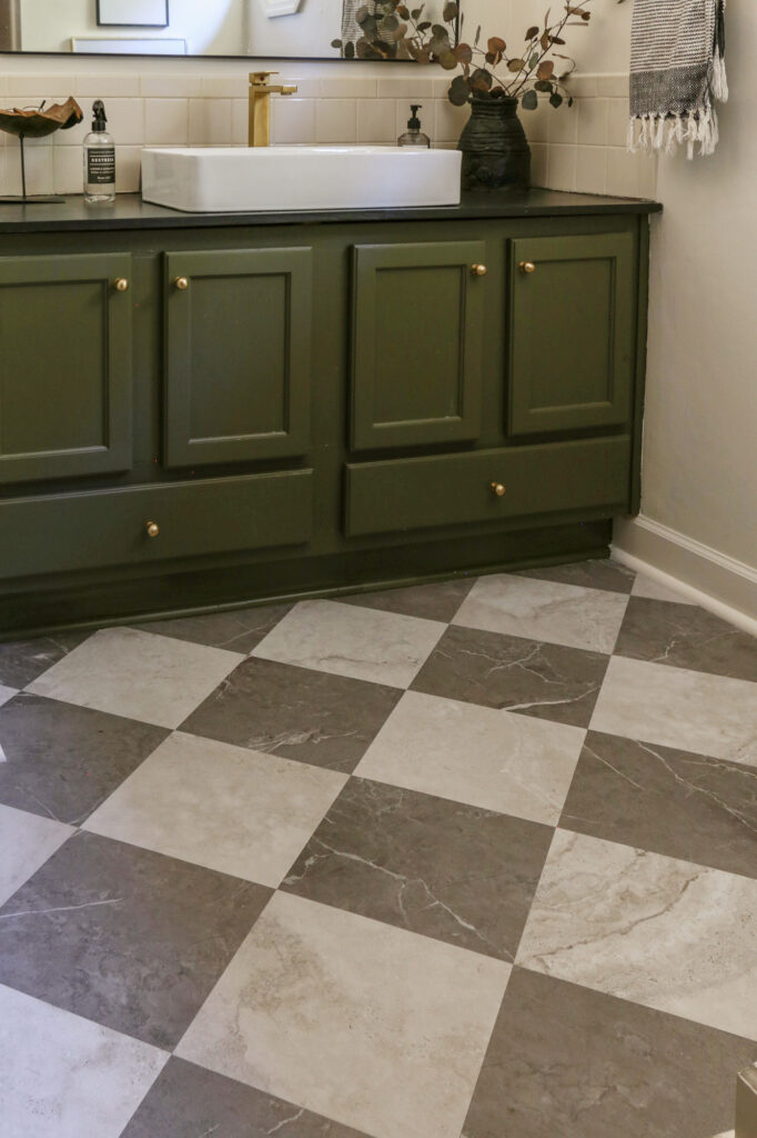 close up view of marble looking peel and stick tiles on bathroom flooring after one year