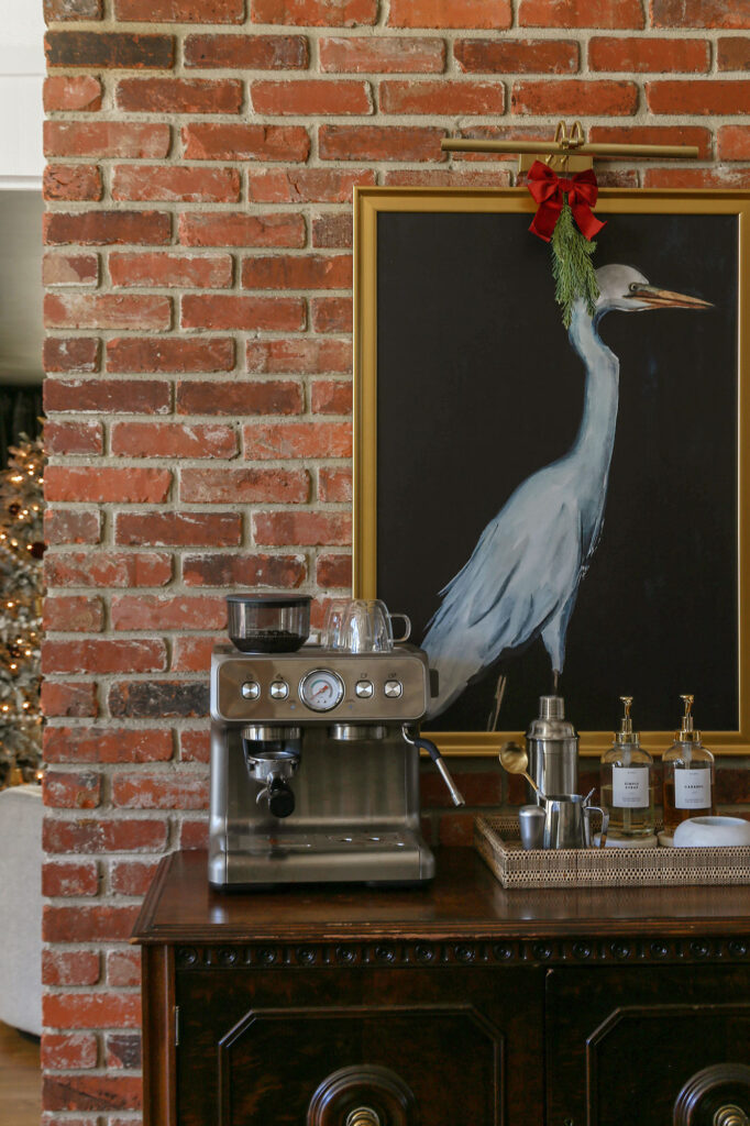 coffee bar decorated for christmas with garland and burgundy ribbon