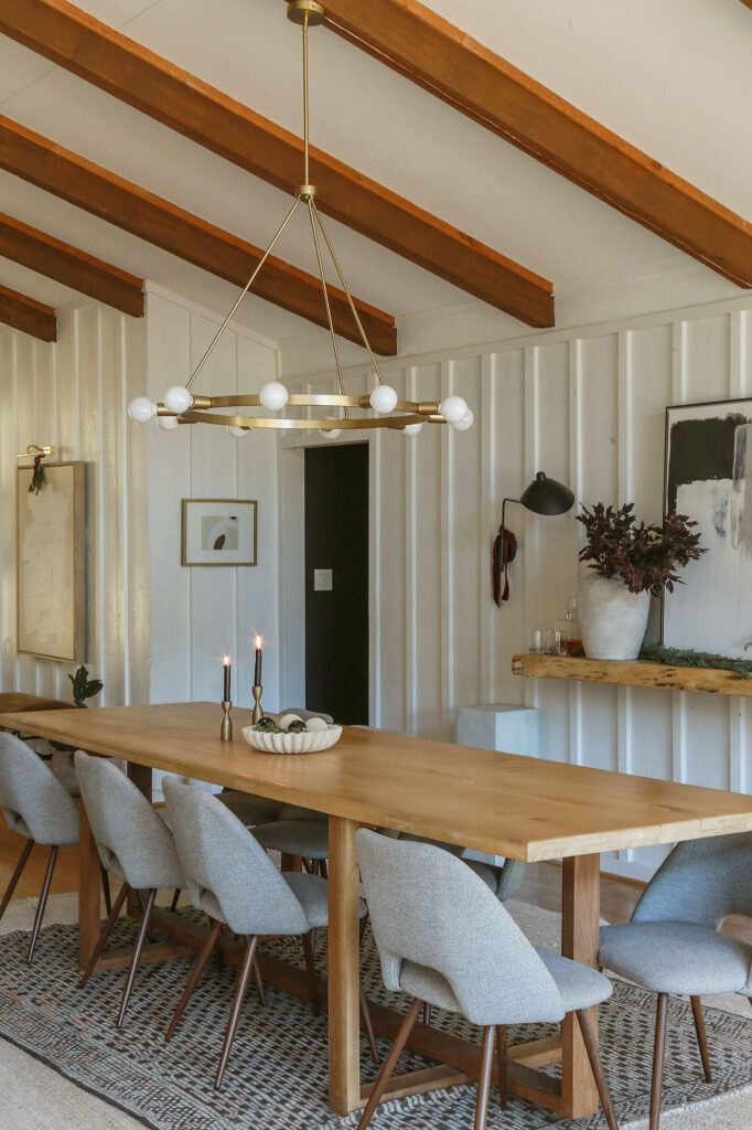 organic modern dining room decorated with burgundy ribbon and neutral, minimal christmas decor 