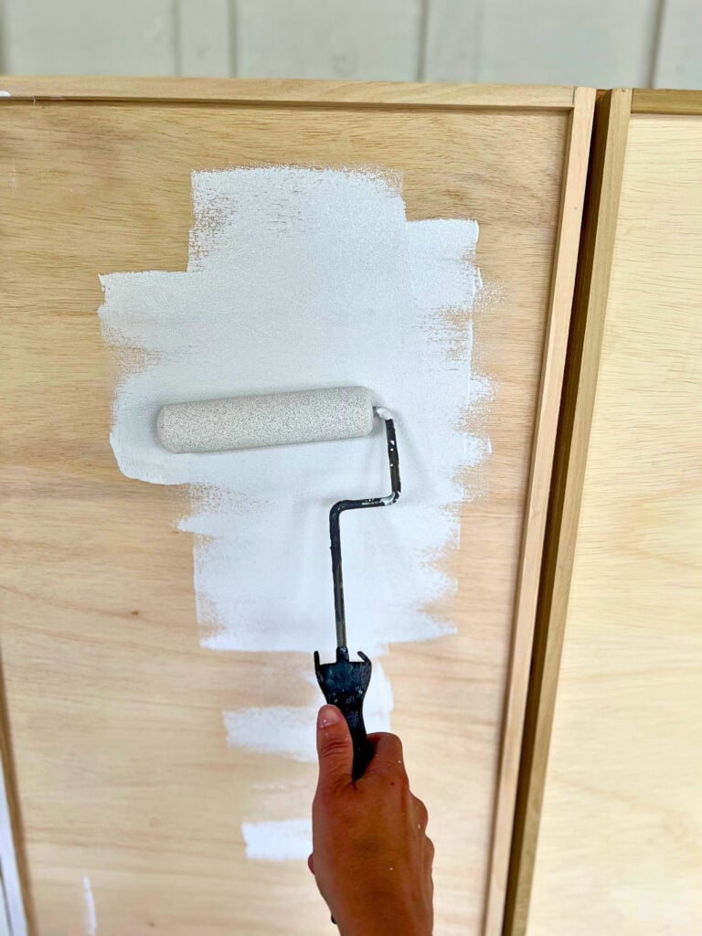 painting diy raw wood cabinets with emerald urethane paint by sherwin williams using a roller and paint brush