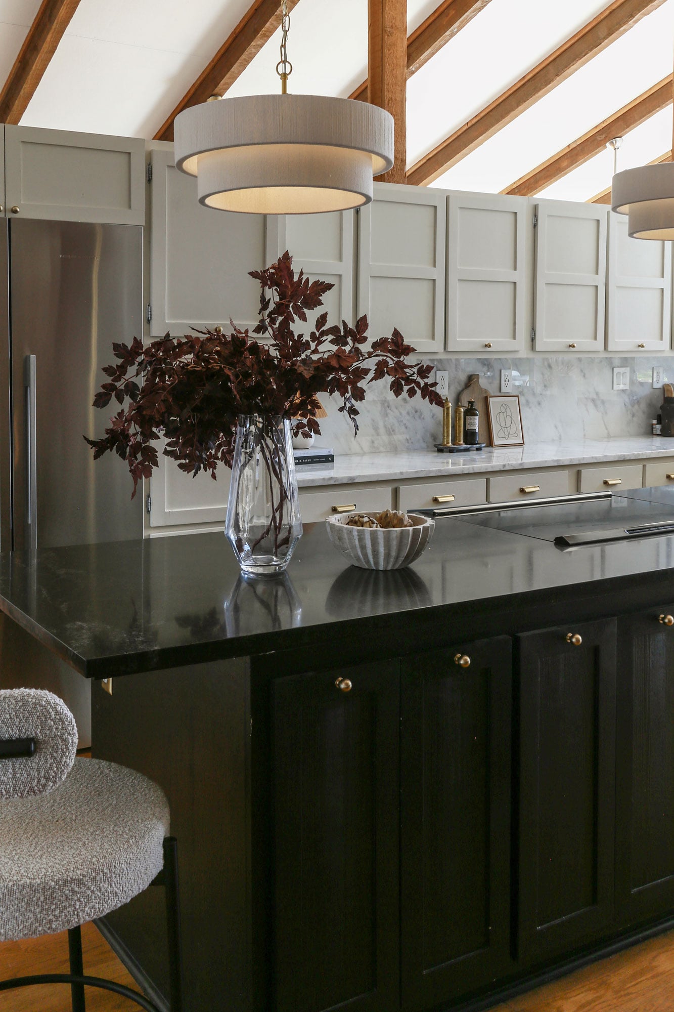 kitchen cabinets painted tricorn black with brass knobs