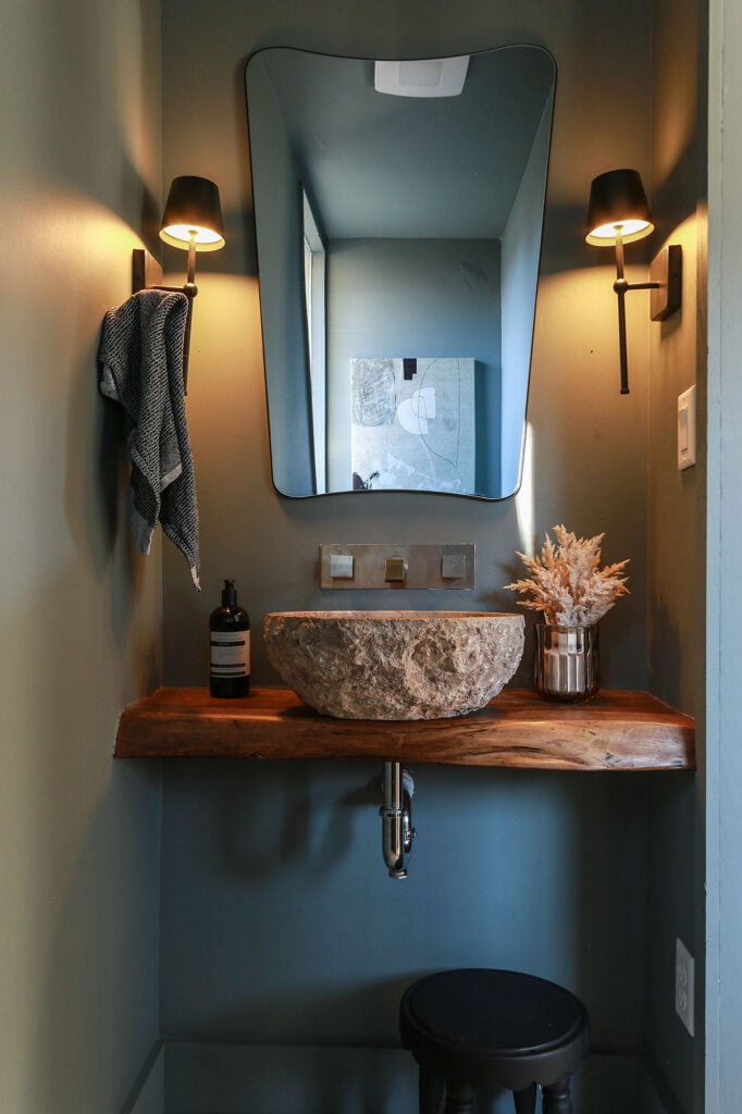 moody powder room on a budget using dark paint, stone vessel sink and wood ledge vanity