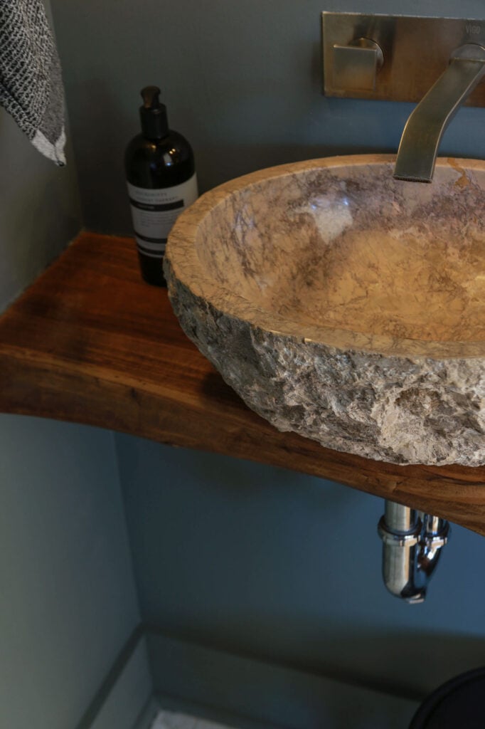 stone vessel sink in moody powder room
