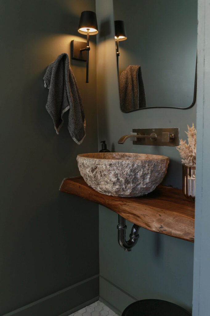 moody powder room with floating wood vanity