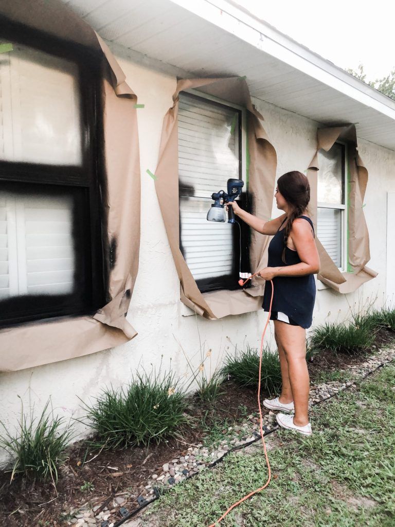 painting the exterior of a home white and windows black diy style 