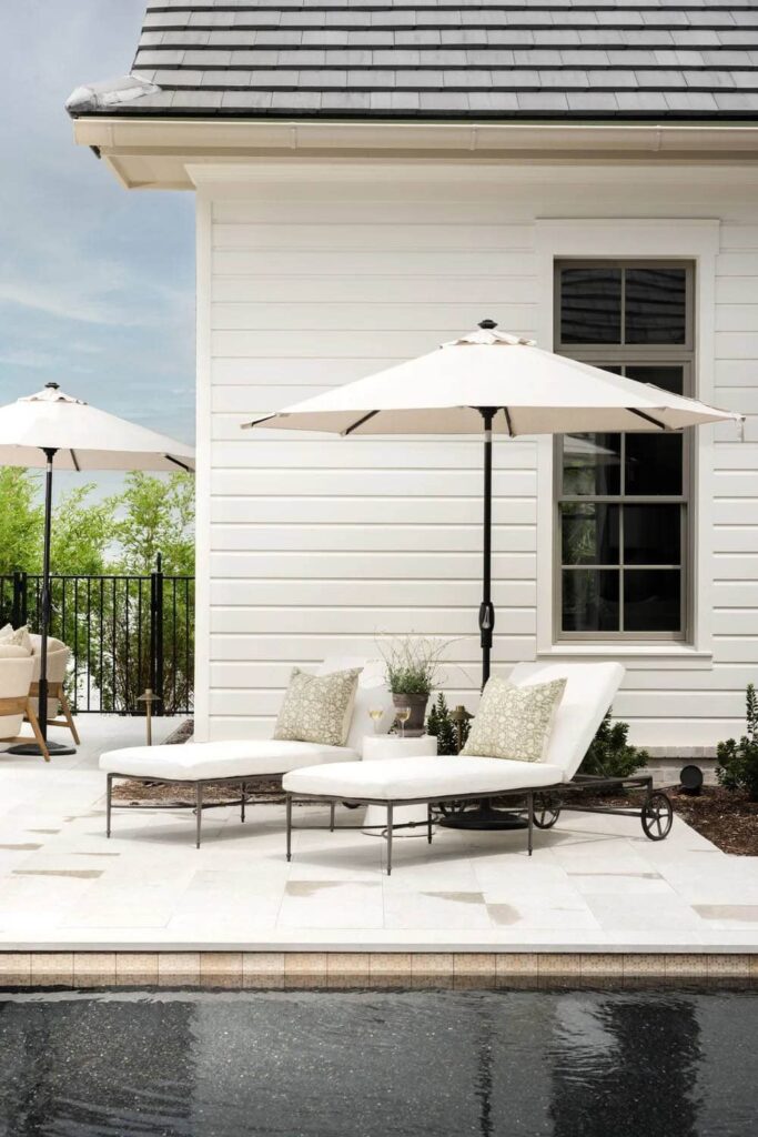 2 chaise loungers sitting catty-corner by pool