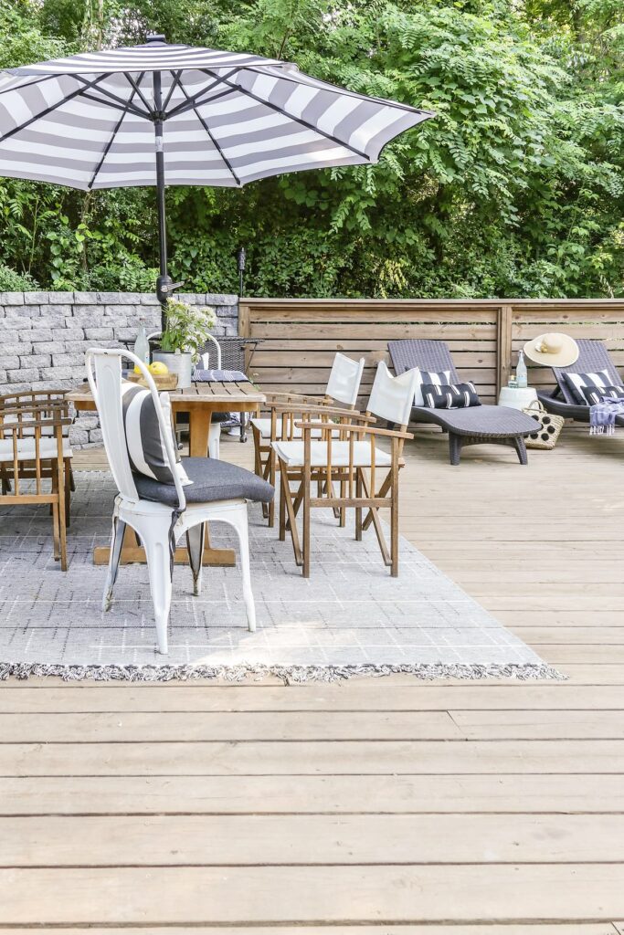 pool deck with stylish dining table and 2 chaise loungers