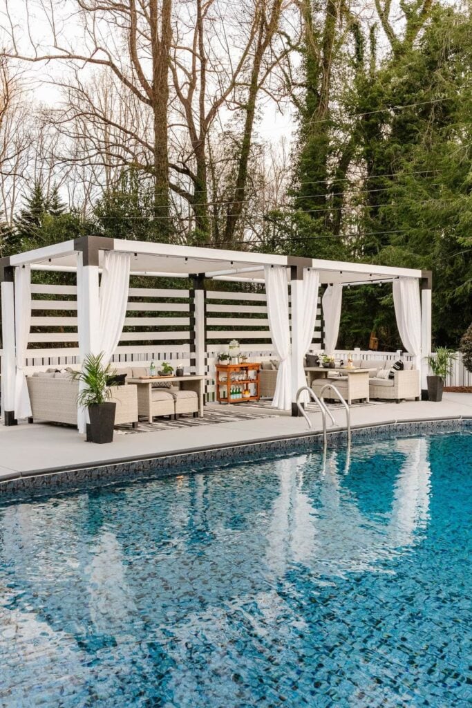 2 diy cabanas next to pool with sofa seating areas