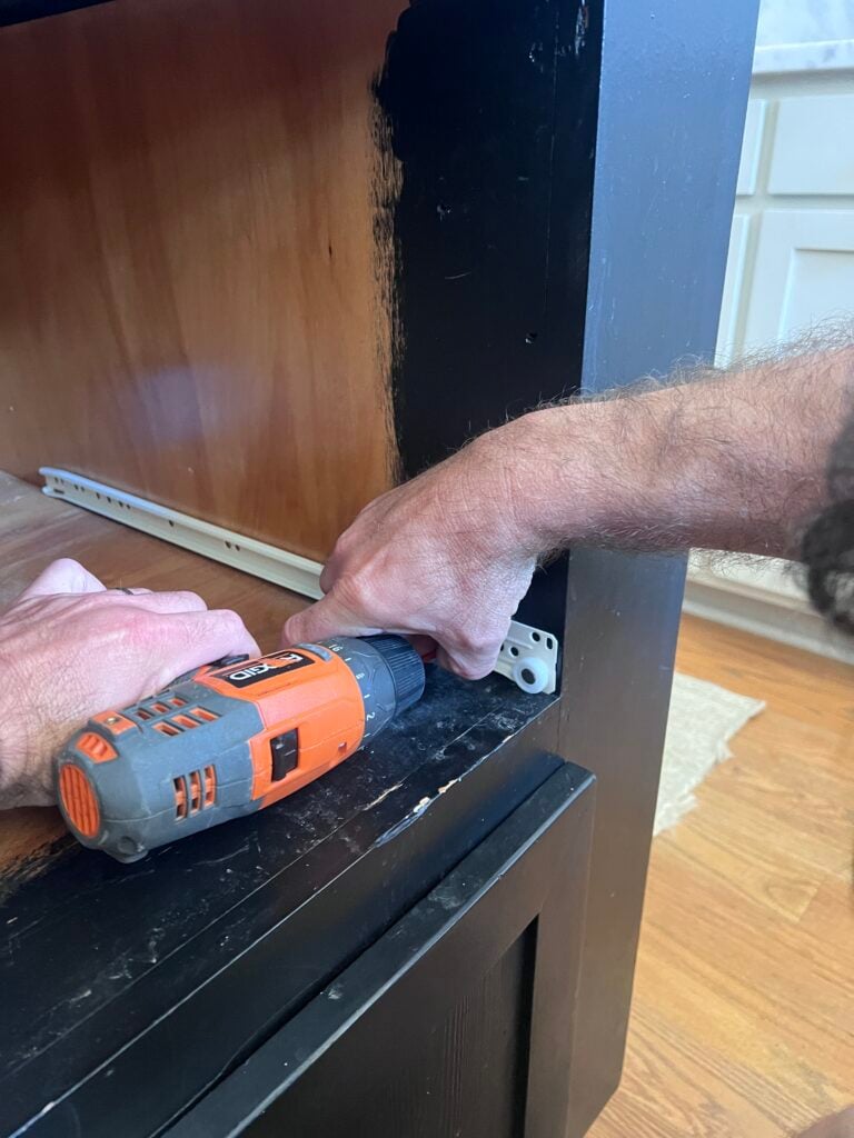 sliding track system for drawer being installed on cabinetry opening of kitchen island