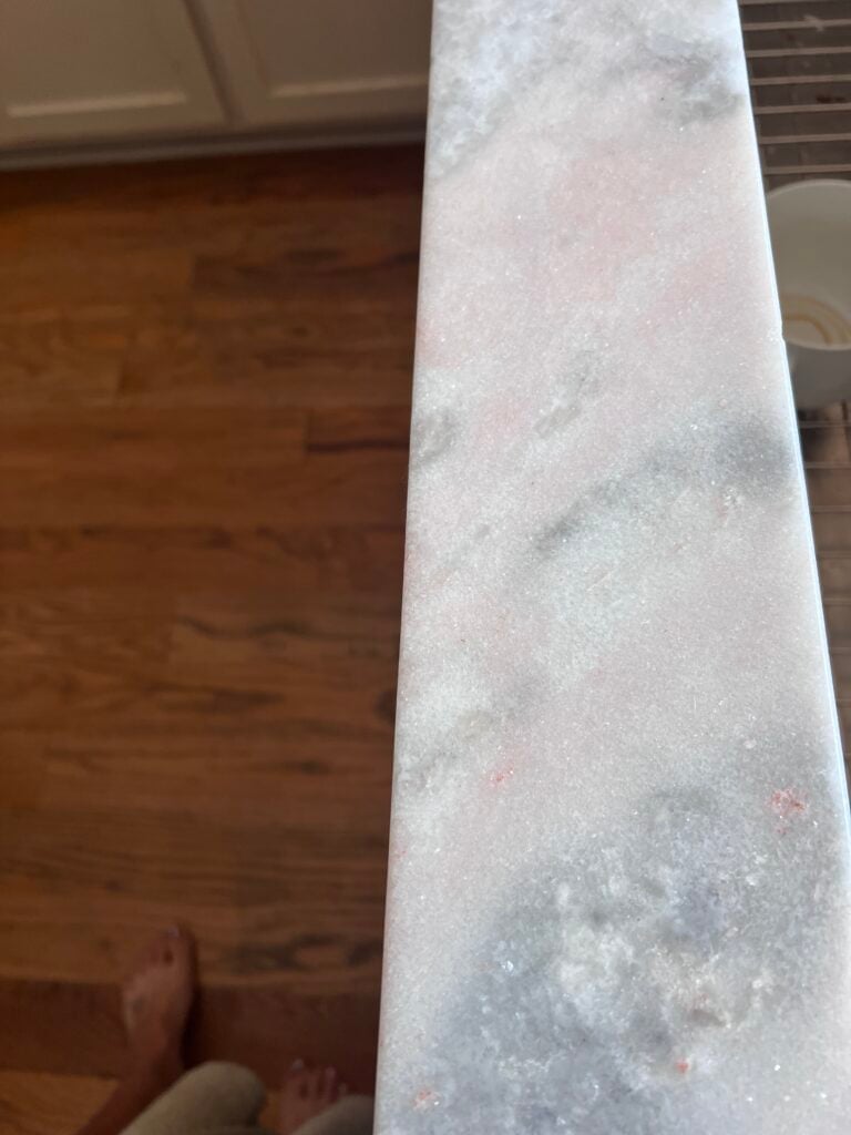 oxidation of natural stone countertops from brazil with pink discoloration around sink