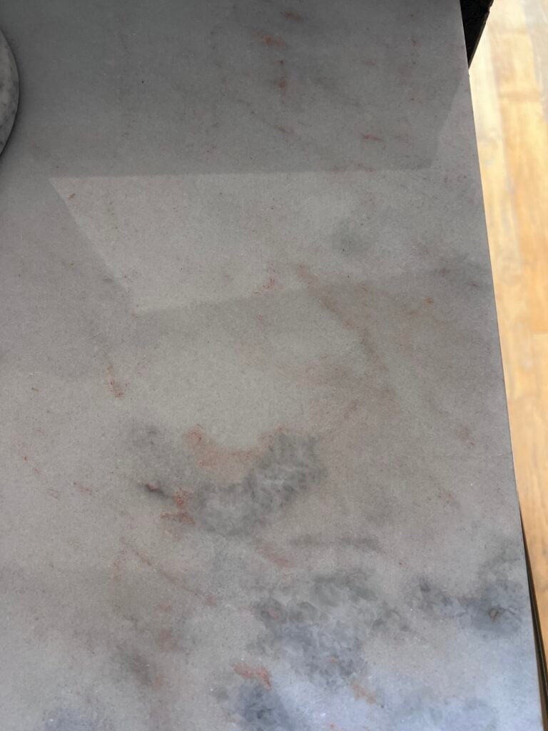 oxidation of natural stone countertops in kitchen over dishwasher 