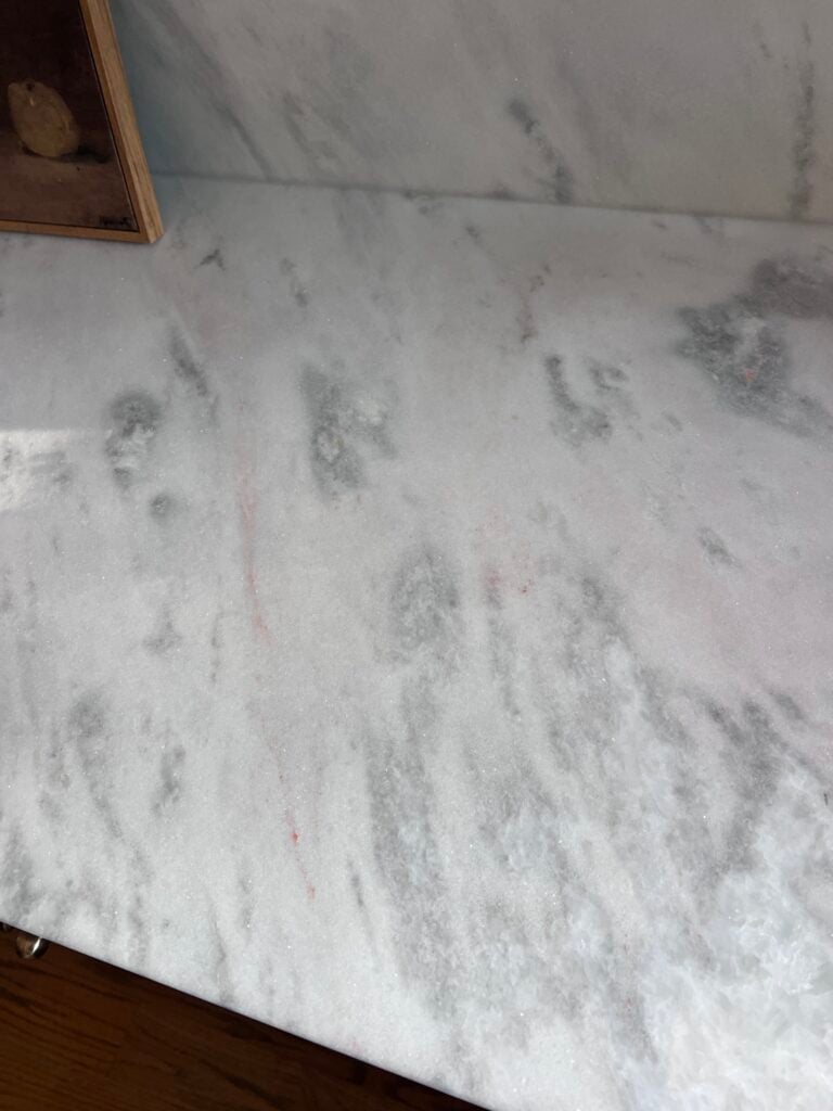marble turning pink and rust colored due to iron deposits in the stone 
