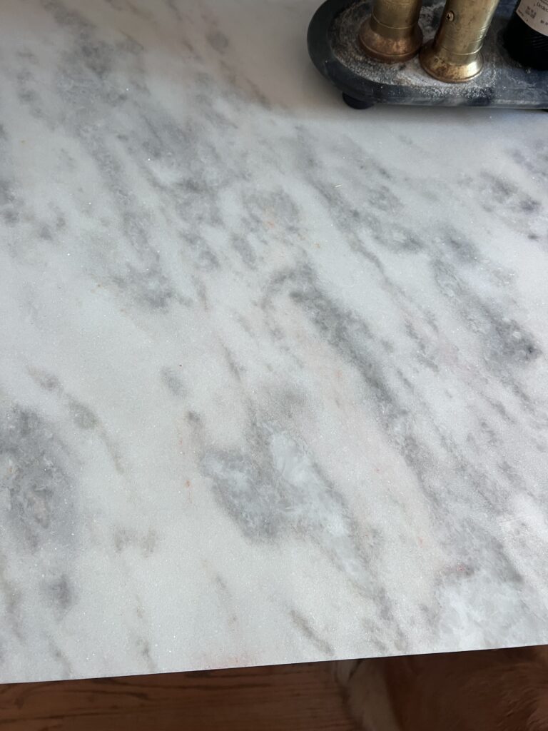 pink and rust discoloration on marble countertops due to iron deposits and oxidation