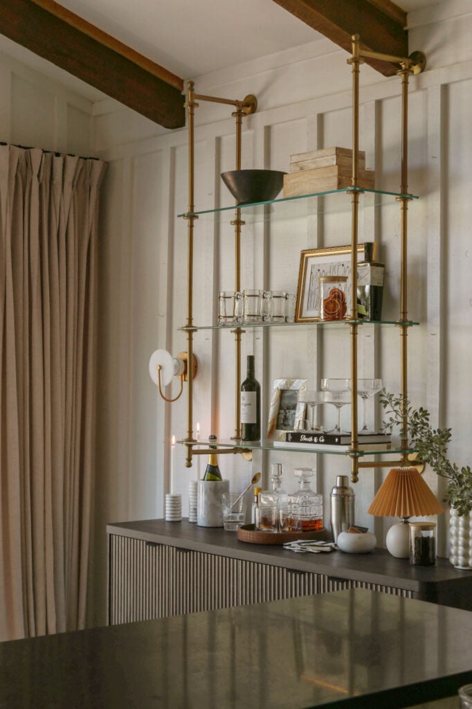 Affordable brass bistro shelves creating a custom built-in look above a home bar