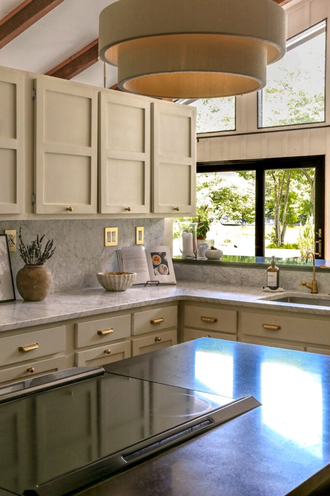 kitchen with black granite on island and honed carrara marble on perimeter counters