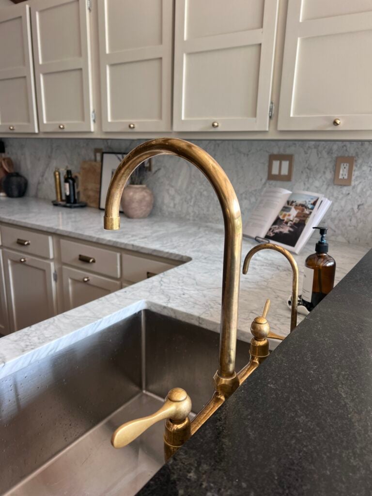 back view of an Unlacquered Brass Faucet in kitchen showing signs of patina 