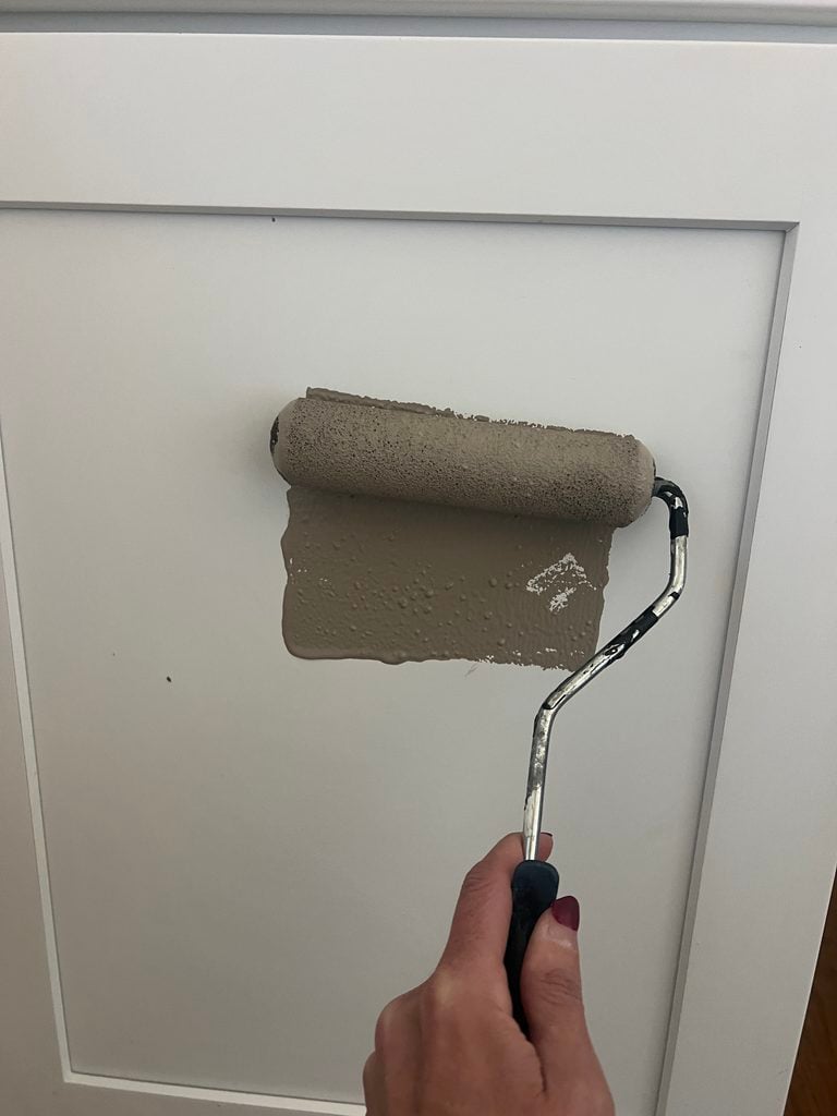 using a roller to paint moth wing by sherwin williams over white cabinets