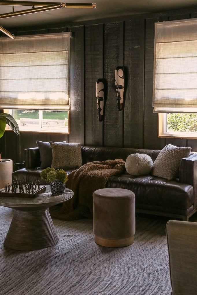 linen roman shades in dark color drenched living room 