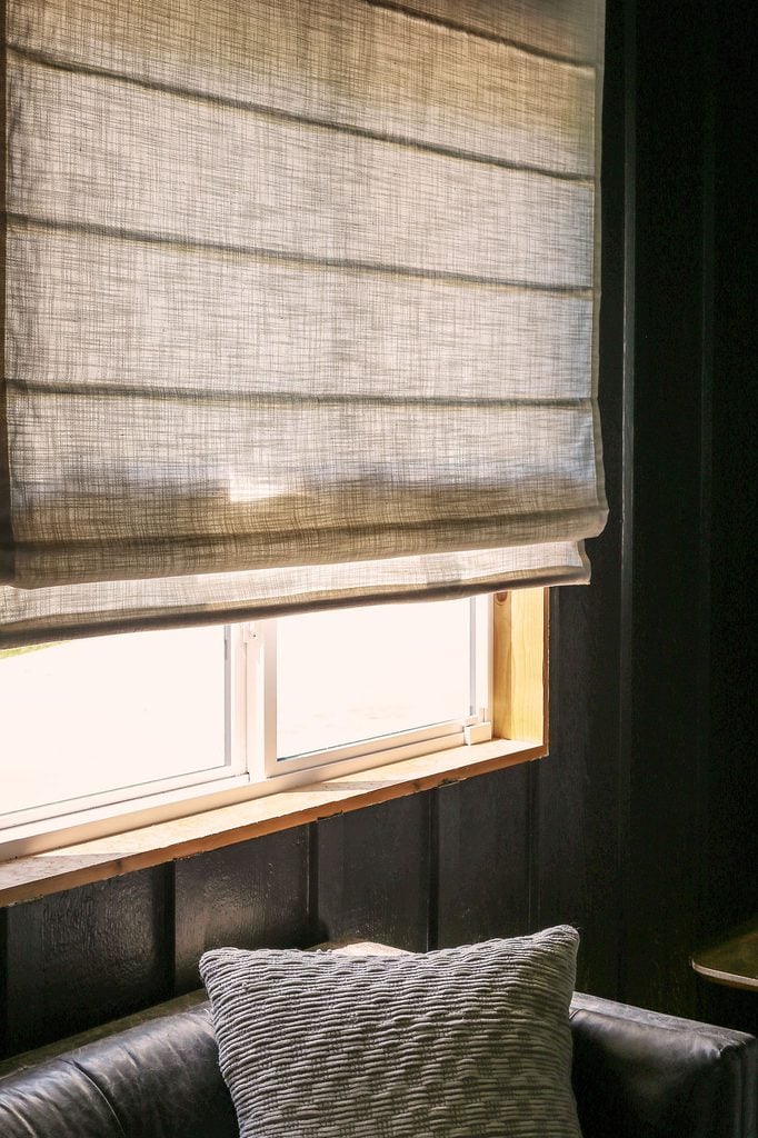 linen roman shades in living room letting in lots of natural light
