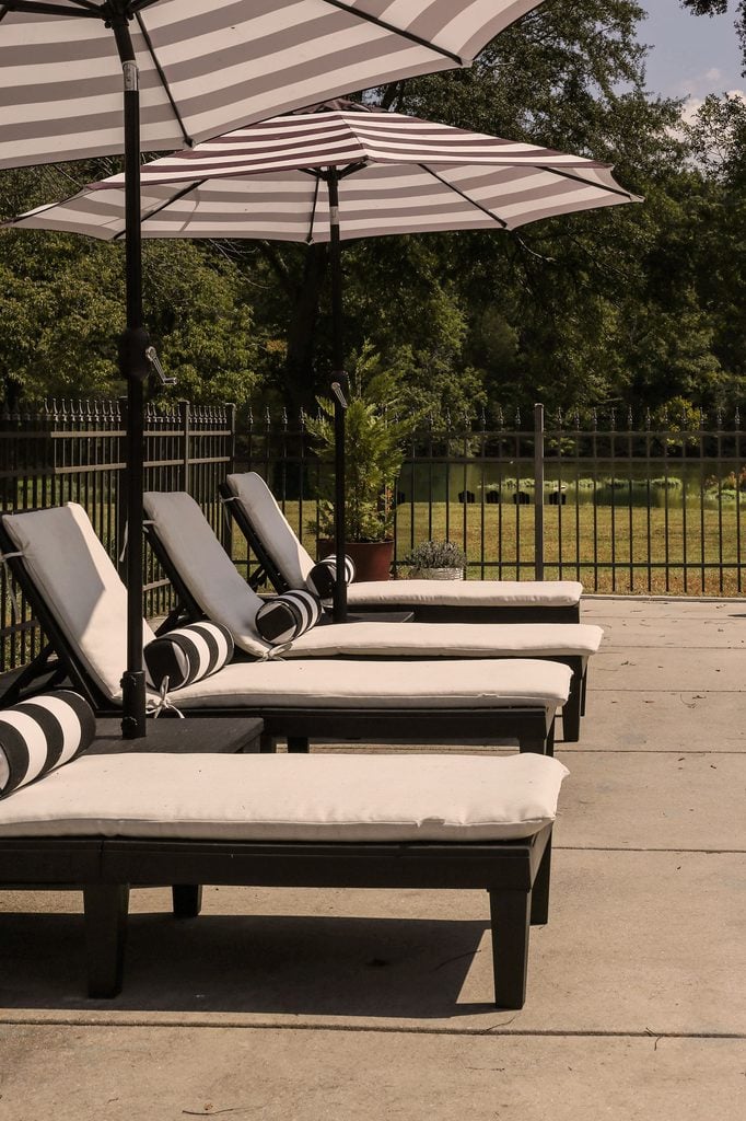 cabana style outdoor furniture arranged by pool