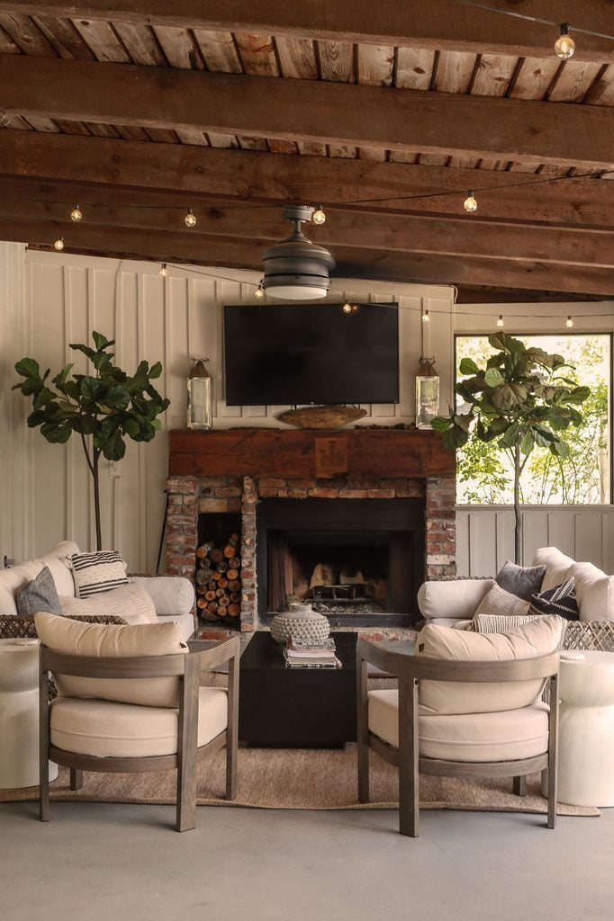 screened in porch with brick fireplace and tv area