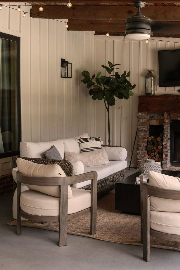 modern screened in porch with fireplace and tv