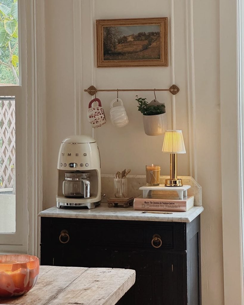 coffee maker styled on a vintage sideboard furniture piece